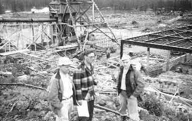 Mervyn Upham, R.C. Hart and Franc Joubin watch the construction of the headframe and mill building of the Quirke uranium mine near Elliot Lake, Ont., in the late spring of 1955.