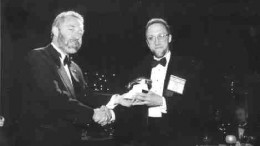 Tracey Savein, South Paw productionsDonald Birak of Hudson Bay Mining & Smelting receives the Prospector of the Year Award from John Steele, president of the PDAC.