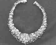 The Milky Way necklace, pictured here, was designed by Canadian artist William Reid (1920-1988) using a base of small gold pyramids, superimposed by a series of fine gold wire sections set with small diamonds.