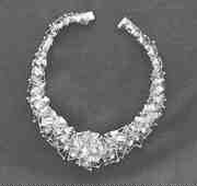 The Milky Way necklace, pictured here, was designed by Canadian artist William Reid (1920-1988) using a base of small gold pyramids, superimposed by a series of fine gold wire sections set with small diamonds.