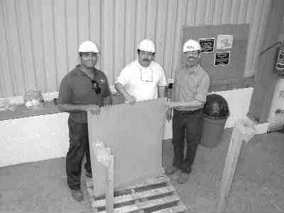 Penoles and BacTech personnel hold a copper cathode produced at the Monterrey demonstration plant.