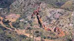 The closing of the La Terrible glory hole, with the Libertad entrance to the lowermost historical workings shown on the left. The hole is more than 200 metres deep.