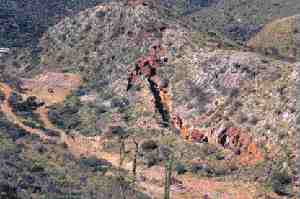 The closing of the La Terrible glory hole, with the Libertad entrance to the lowermost historical workings shown on the left. The hole is more than 200 metres deep.