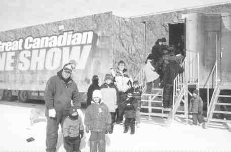 Visitors pose outside The Great Canadian Mine Show during a trip to Yellowknife, N.W.T. The show travelled 76,000 km in one year, and more than 40,000 guests witnessed its exhibits.