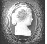 This cameo brooch from the 19th century is made from grey and white agate set in gold with black enamel detail.
