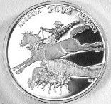 The newly minted coin, pictured here, depicts a saddle bronco and rider with a chuck wagon rig emerging from below. The Calgary Saddledome is in the background.