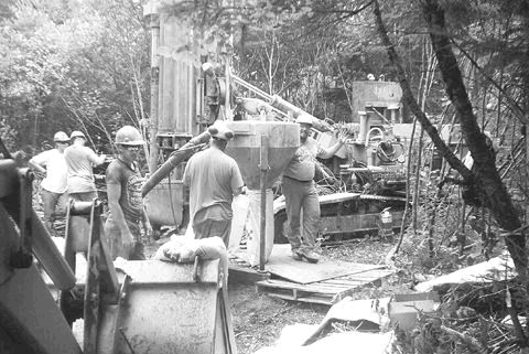 Workers operate a percussion drill rig during Aurogin Resources' August drilling program at the Moose River gold project in north-central Nova Scotia.