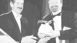 Robert McEwen (left) of Goldcorp receives the Viola MacMillan Award for Developer of the Year for 2001 from Mark Smith of First Associates.