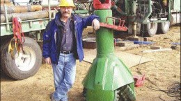 Brent Jellicoe, project manager with Kensington Resources, stands beside a milled-tooth tri-cone drill bit, which measures 36 inches in diameter at the base. Drilling contractor Layne Christensen modified the former oil rig drill bit for the Fort  la Corne project in northern Saskatchewan.