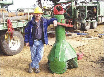 Brent Jellicoe, project manager with Kensington Resources, stands beside a milled-tooth tri-cone drill bit, which measures 36 inches in diameter at the base. Drilling contractor Layne Christensen modified the former oil rig drill bit for the Fort  la Corne project in northern Saskatchewan.