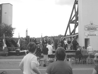 Onlookers watch as Benot Serr, member of Parliament for Timiskaming-Conchrane, declares the Cobalt mining district a national historic site. The headframe on the left was taken from the nearby Pan Silver mine.