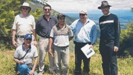 Photo by John Cumming At the Sechol nickel-laterite property in Guatemala, with the El Inicio deposit in the left background, and Lake Izabal in the far middle background. From left: Robert Callander, vice-president of Caldwell Securities; Hugo Matzer Milian (kneeling), manager of public relations for Jaguar Nickel subsidiary Minera Mayamerica; Somerset Parker, Jaguar senior marketing executive; Byron Chinchilla, Mayamerica employee; Ricardo Valls, Jaguar chief geologist; and John Redstone, senior metals & mining analyst at Scotia Capital, Jaguar's financial advisor.