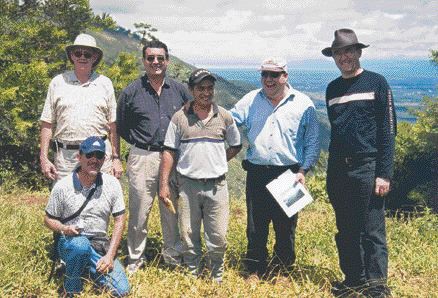 Photo by John Cumming At the Sechol nickel-laterite property in Guatemala, with the El Inicio deposit in the left background, and Lake Izabal in the far middle background. From left: Robert Callander, vice-president of Caldwell Securities; Hugo Matzer Milian (kneeling), manager of public relations for Jaguar Nickel subsidiary Minera Mayamerica; Somerset Parker, Jaguar senior marketing executive; Byron Chinchilla, Mayamerica employee; Ricardo Valls, Jaguar chief geologist; and John Redstone, senior metals & mining analyst at Scotia Capital, Jaguar's financial advisor.