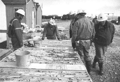 Analysts examine core from the Boston deposit during a visit in 2000.