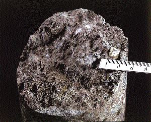 A large diamond with exposed surfaces measuring 8.8 mm by 8.2 mm by 4.8 mm, found in drill core from the Renard 65 kimberlite in the Otish Mountains of north-central Quebec. The diamond weighs about 4 carats.