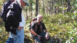 At Rare Earth Metals' Assean Lake project in Manitoba, Director Bob Sibthorpe (left foreground) discusses soil samples with Project Geologist Dan Ziehlke.