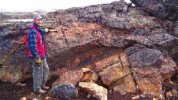 Commander Resources' Project Geologist Lamont Leatherman at an outcrop of the gold-bearing Bravo iron formation at the Ridge Lake prospect on Baffin Island.