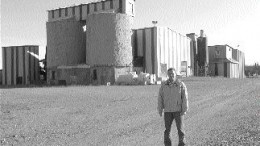 Photo by Pattie BealesPhilippe Cloutier, a consulting geologist with Alexis Minerals, stands in front of the Aurbel mill, which is no longer in operation. Alexis has an option to buy the mill from Aur Resources.