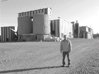 Photo by Pattie BealesPhilippe Cloutier, a consulting geologist with Alexis Minerals, stands in front of the Aurbel mill, which is no longer in operation. Alexis has an option to buy the mill from Aur Resources.