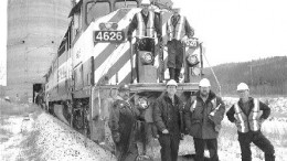 The first train-load of metallurgical coal from Western Canadian Coal's Dillon mine. On top, from left: Rail operators Bruce Zimmers and Dale Groves with fellow operators Ren Rochon (bottom left), Robert Vandale, Dillon Mine Superintendent Michael LaCarte, and operator Jerry Tobin.