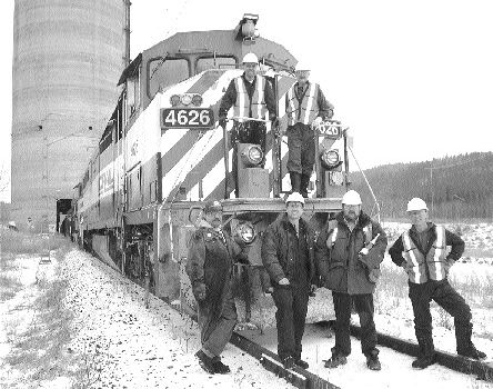 The first train-load of metallurgical coal from Western Canadian Coal's Dillon mine. On top, from left: Rail operators Bruce Zimmers and Dale Groves with fellow operators Ren Rochon (bottom left), Robert Vandale, Dillon Mine Superintendent Michael LaCarte, and operator Jerry Tobin.