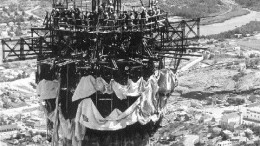 On July 26, 1973, crews from Custodis Canadian Chimney mark the completion of the 820-ft. concrete portion of Hudson Bay Mining & Smelting's stack in Flin Flon, Man.