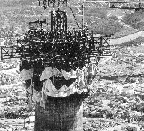 On July 26, 1973, crews from Custodis Canadian Chimney mark the completion of the 820-ft. concrete portion of Hudson Bay Mining & Smelting's stack in Flin Flon, Man.