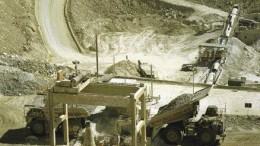 Trucks unload copper ore into a crusher at the Cerro Verde mine in Peru.
