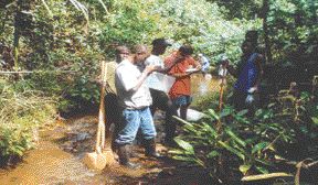 A field team from Mano River stands on the outcrop of the first known diamondiferous kimberlite pipe in Liberia, which was discovered in 2000.