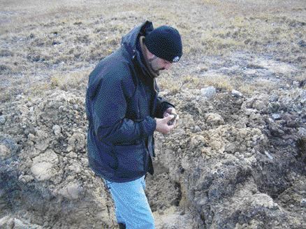 Diamonds North Resources Exploration Manager Graham Gill examines kimberlite outcrop on the King Eider trend, situated on the Blue Ice property on Victoria Island.