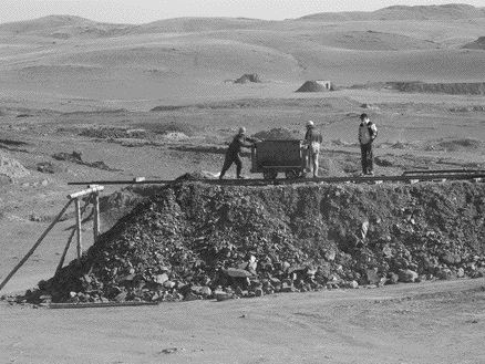 Workers load the leach pad at Jinshan Gold Mines' CSH 217 project in northern China.