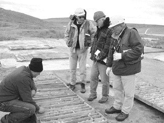 Photo by Stephen StakiwFrom left: Galileo Equities mining analyst Glenn Brown, Western Prospector Consulting Geologist Gerald Harper, Haywood Securities analyst Jim Mustard and Western Prospector Geologist Wilfried Meyer examine high-grade uranium core from Saddle Hills hole 5006.