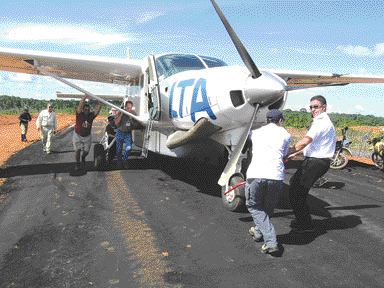 Grounded: Crystallex executives didn't know it at the time but this photo of company executives pushing a plane stuck on a runway in Venezuela -- taken by The Northern Miner during a recent site visit -- would serve as a metaphor for the company's troubles in the Latin American nation. The Crystallex saga in Venezuela took a strange turn recently when President Hugo Chavez made statements in support of nationalizing the country's mineral assets.