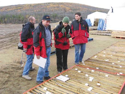 Sherwood Copper President Stephen Quin (second from left) looks at core from the Minto copper-gold project with members of the media and analysts during a recent tour of the project.