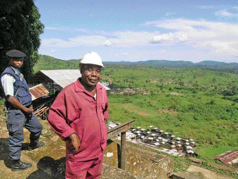 Photo by Anthony VaccaroMoto Goldmines geologist Guillaume Kiza overlooks a gold-rich valley in the northeastern Democratic Republic of the Congo. Nearby, a member of a government-sanctioned private police force acts as security -- a quiet reminder that danger is never far off in the developing world. In our 4-page feature on Mining in Africa, staff writer Anthony Vaccaro talks with a company that helps junior exploration companies like Moto decide to move forward or simply walk away.