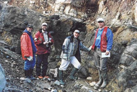 A trench excavated in 2005 on the Lynx dyke system, part of the Foxtrot diamond property in north-central Quebec. Foxtrot is held by a joint venture between Ashton Mining of Canada and Quebec-owned Soquem. From left: Ghislain Poirier, assistant manager of exploration with Soquem; Tyson Birkett, Soquem's project manager; Pierre Bertrand, Soquem's vice-president of exploration; and Al O'Connor, project manager with Ashton Mining of Canada.