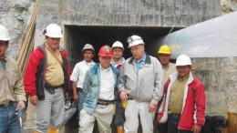 Greystar Resources vice-president Frederick Felder (red hardhat) and president David Rovig (on Felder's left) pose with employees at a portal leading into the Angostura gold deposit.