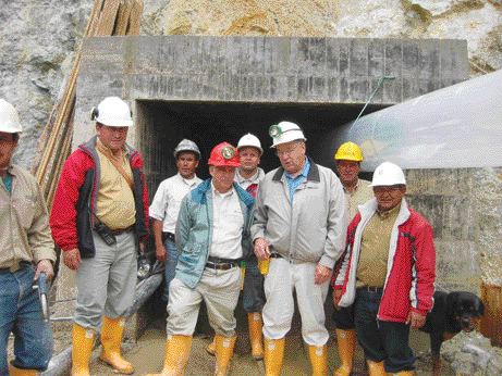 Greystar Resources vice-president Frederick Felder (red hardhat) and president David Rovig (on Felder's left) pose with employees at a portal leading into the Angostura gold deposit.