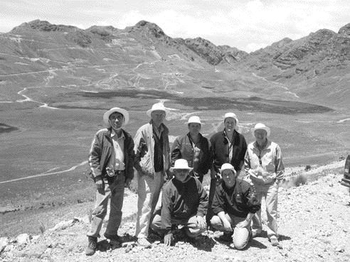 The Northern Peru Copper team (back row, from left): Senior geologist Carlos Miranda, country manager Hal Waller, president and CEO Marshall Koval, vice-president of exploration Leo Hathaway, and director Tony Floyd. In front is project manager Jeff O'Toole (left), and vice-president of corporate development David Strang. The main Galeno deposit and exploration camp are in the background.