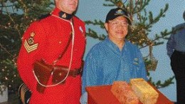 SAN GOLDSergeant Douglas Ashton of the Powerview, Man., RCMP detachment and James Wong, chief underground geologist with San Gold, pose with two gold bars poured from the company's new Rice Lake mine, near Bissett in northern Manitoba.