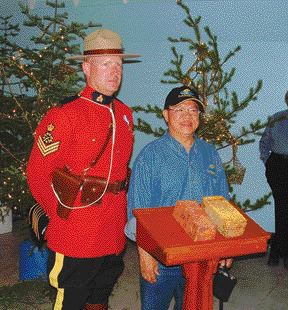 SAN GOLDSergeant Douglas Ashton of the Powerview, Man., RCMP detachment and James Wong, chief underground geologist with San Gold, pose with two gold bars poured from the company's new Rice Lake mine, near Bissett in northern Manitoba.