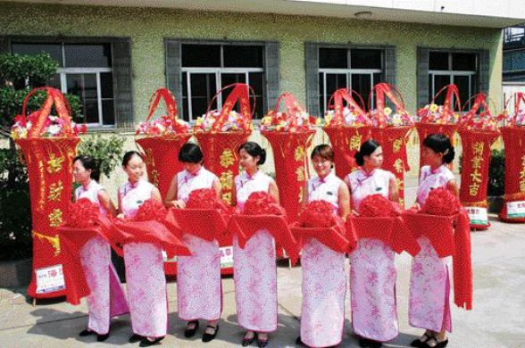 MICHELAGOA traditional Chinese ceremony in July 2005 marks the transfer of the bacterial oxidation plant in the gold-mining town of Laizhou, Shandong province, to Aussie miner, Michelago. The pillars in the background represent wisdom. And the women are holding trays of flowers, each with a pair of scissors to cut the opening ribbon. The BacOx plant, the largest of its kind in China, processes third-party concentrates at a rate of about 150,000 oz. gold annually and is key to an impending merger between Toronto-based Golden China Resources and Michelago.