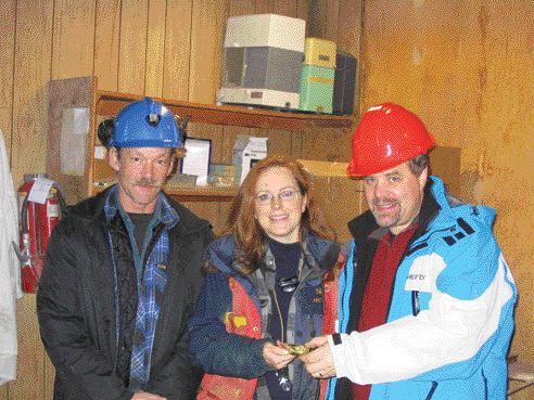 One of the first gold bars to be poured at Cusac Gold Mines' Table Mountain mine in northern British Columbia. From left: Mine manager Kevin Fitzpatrick; vice-president, exploration Lesley Hunt; and Cusac CEO David Brett.