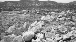 COLUMBIA METALSThe leach pad at the Lluvia de Oro mine in Sonora state, Mexico, with the leach plant in the background. Large run-of-mine boulders were placed on the pad by previous operators without crushing.