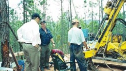 PHOTO BY JOHN CUMMINGUnigold's chairman Talal Ali Al-Shair (left), and COO and vice-president of exploration Daniel Danis (centre) examine a new drill at the company's Los Candelones gold deposit on the Neita property in northwestern Dominican Republic.