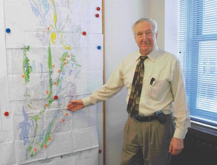 BY STEPHEN STAKIWGGL Diamond president and CEO Ray Hrkac shows the recent Geological Survey of Canada map indicating favourable rocks for a potential nickel belt on its Winter Lake project area north-northeast of Yellowknife, N.W.T.