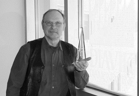 Diavik Diamond Mines' Nick Strus holds his recent award from the Arctic Energy Alliance, a not-for-profit outfit that aims reduce energy use in the Far North.