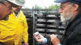 GOLDEN BAND RESOURCESGolden Band Resources' president and CEO Ron Netolitzky (far right), VP exploration and COO Klaus Lehnert-Thiel (left) and scoping study engineer Gene Puritch examine drill core from the company's La Ronge gold project.