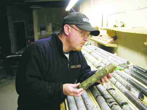 Metalcorp's chief operating officer, Aubrey Eveleigh, examines a piece of massive sulphide mineralization from the BL14 prospect in the company's core shack in Thunder Bay, Ont.
