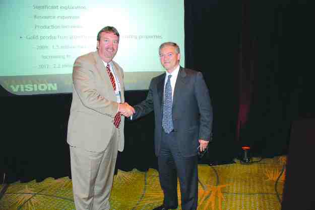 Meridian Gold president and CEO, Ed Dowling (left), and Yamana Gold chairman and CEO Peter Marrone shake hands in Denver's Hyatt Regency Hotel after reaching an agreement on Yamana's increased takeover offer.